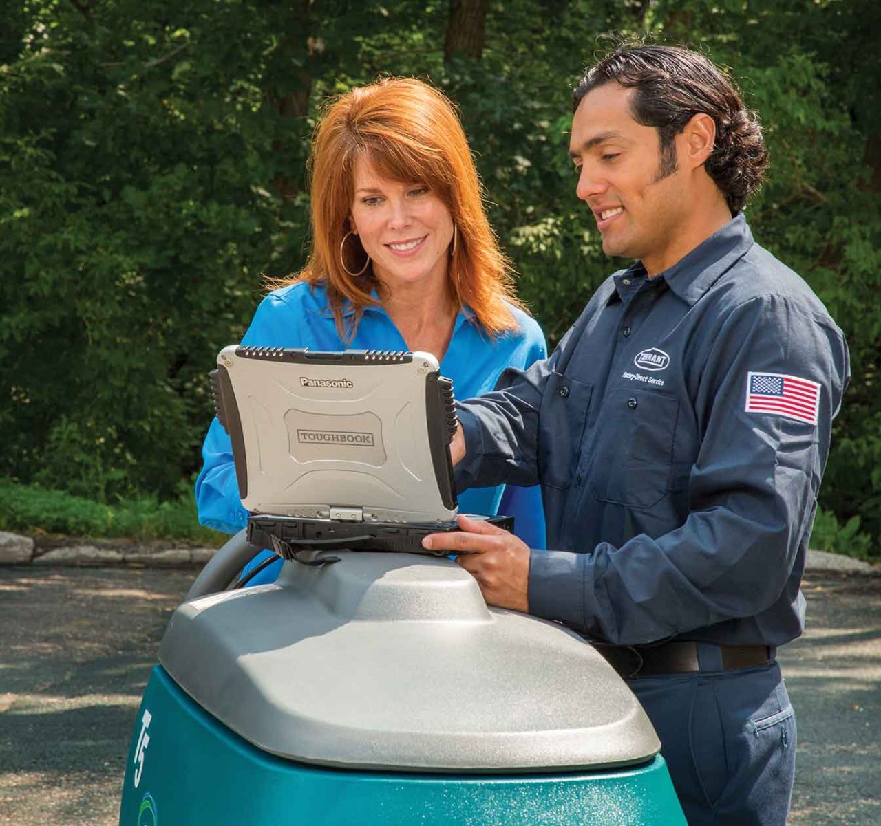 Tennant service technician talking to customer about cleaning equipment